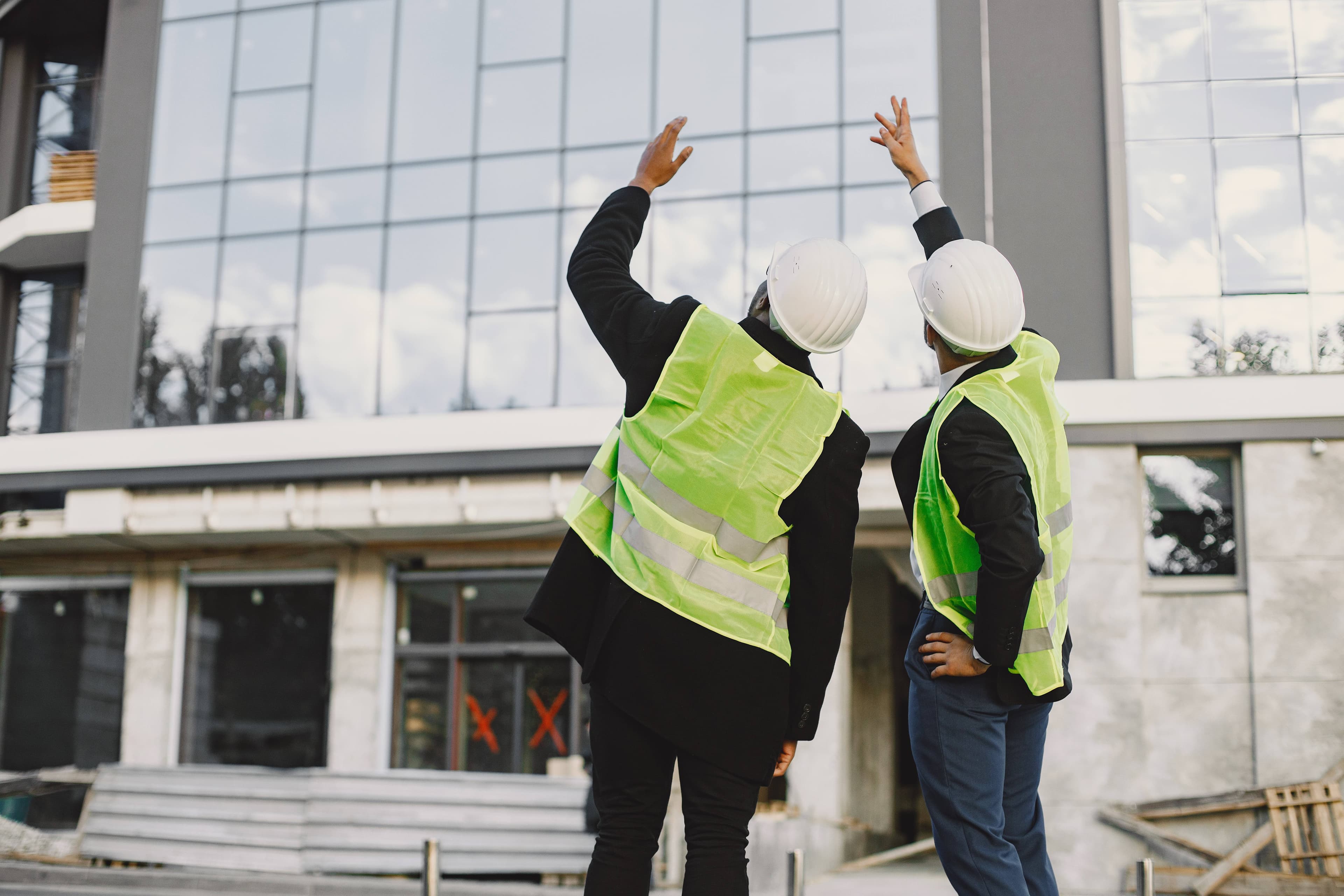 Construction professionals reviewing a building on site